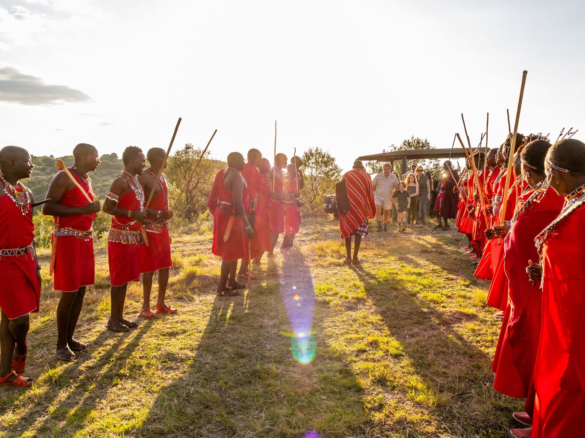 Maasai form an honour guard to welcome Marco and his family