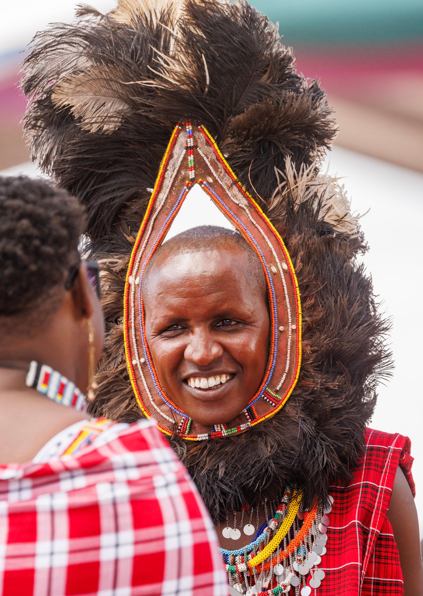 A feathered headdress symbolises heritage, warrior tradition, and community pride