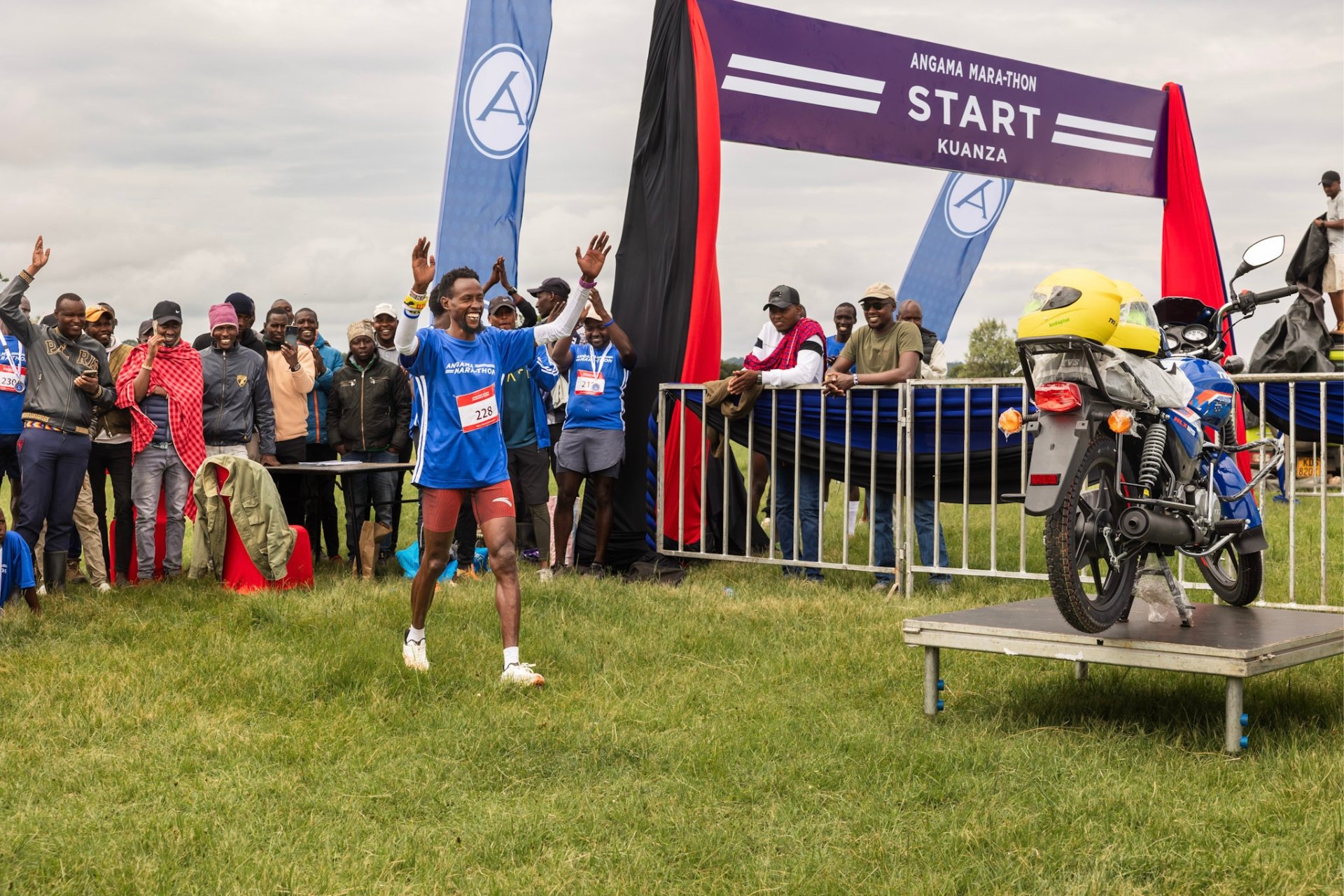 The winner strides towards his brand new motorcycle — though he can probably run faster