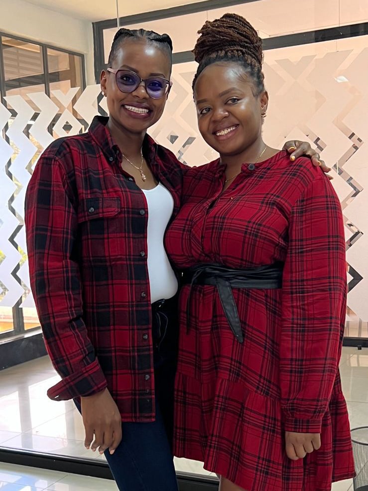 Maria and Rita (Nairobi travel planning and guest logistics) in red plaid