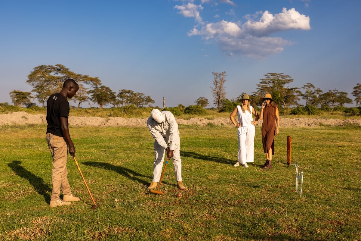 Angama Amboseli Guide Daniel and Timothy playing a close game of croquette 