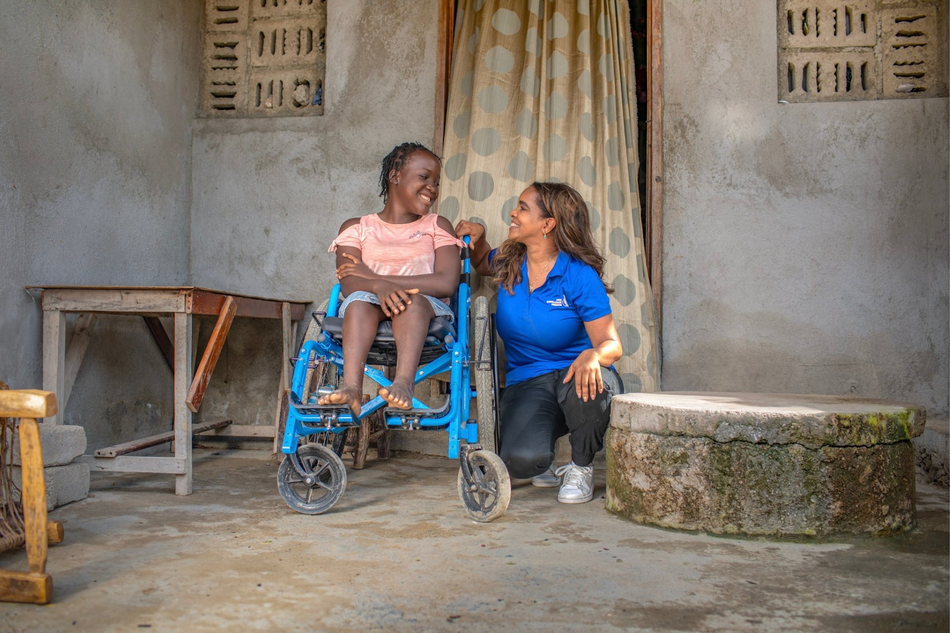 CEO Nuka Hart smiling with Fabienne, a 16-year-old girl in Haiti