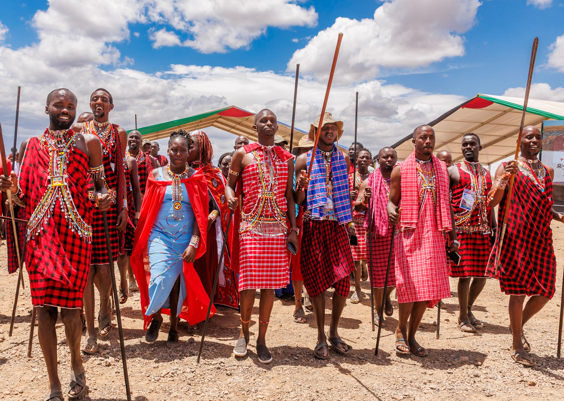 Men and women adorned in colours representing their culture