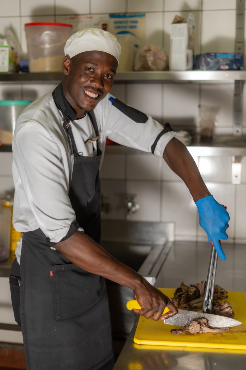 Joseph chops up some nyama choma, hot off the grill 
