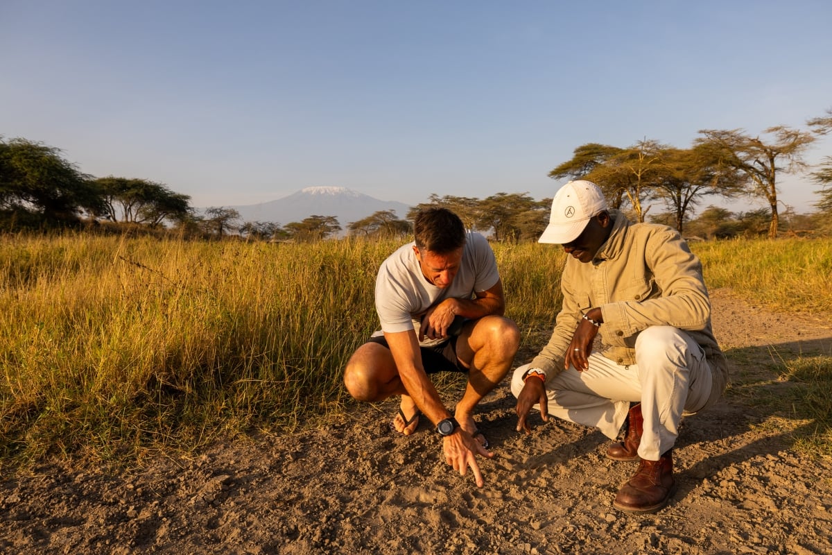 Amboseli Guide Salash tracking lions with Rosco