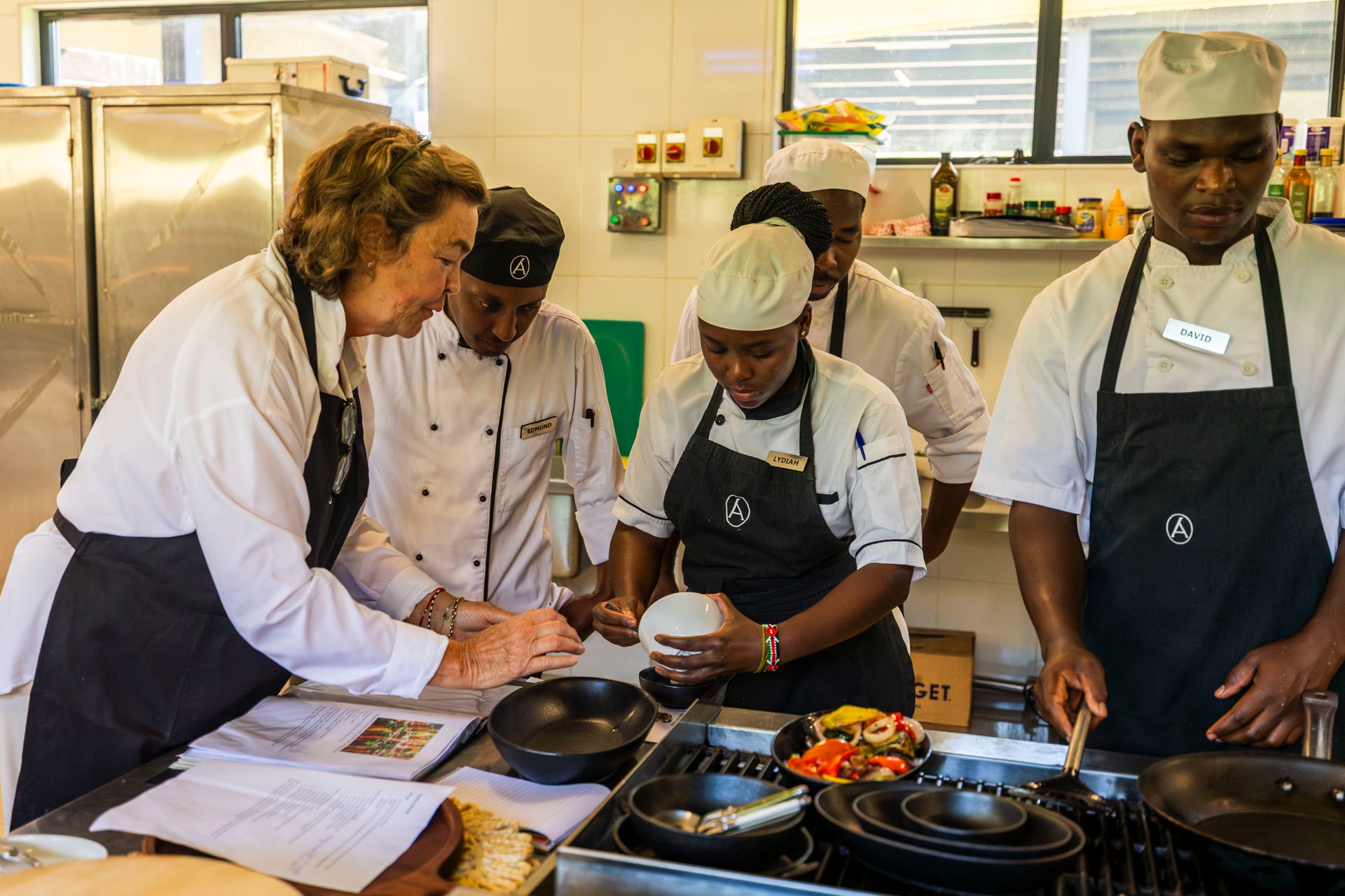 Lydiah and the kitchen crew lean in