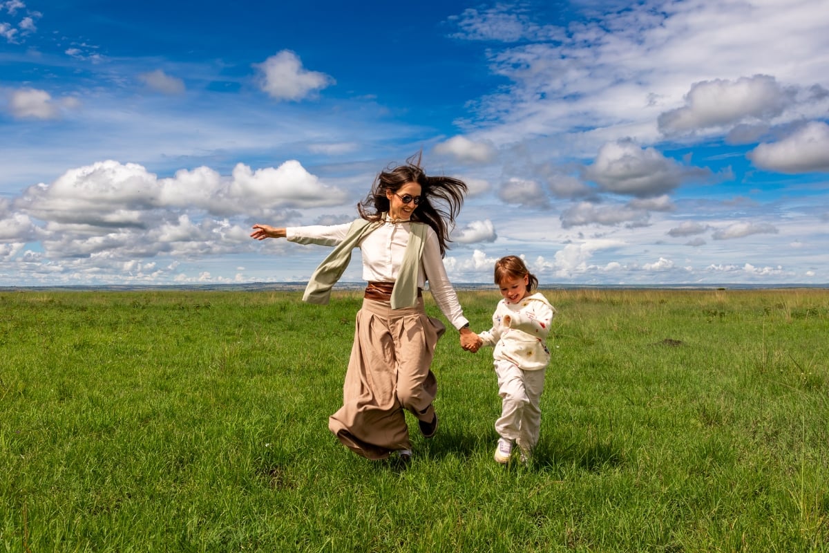 While a mother and daughter play in the Maasai Mara