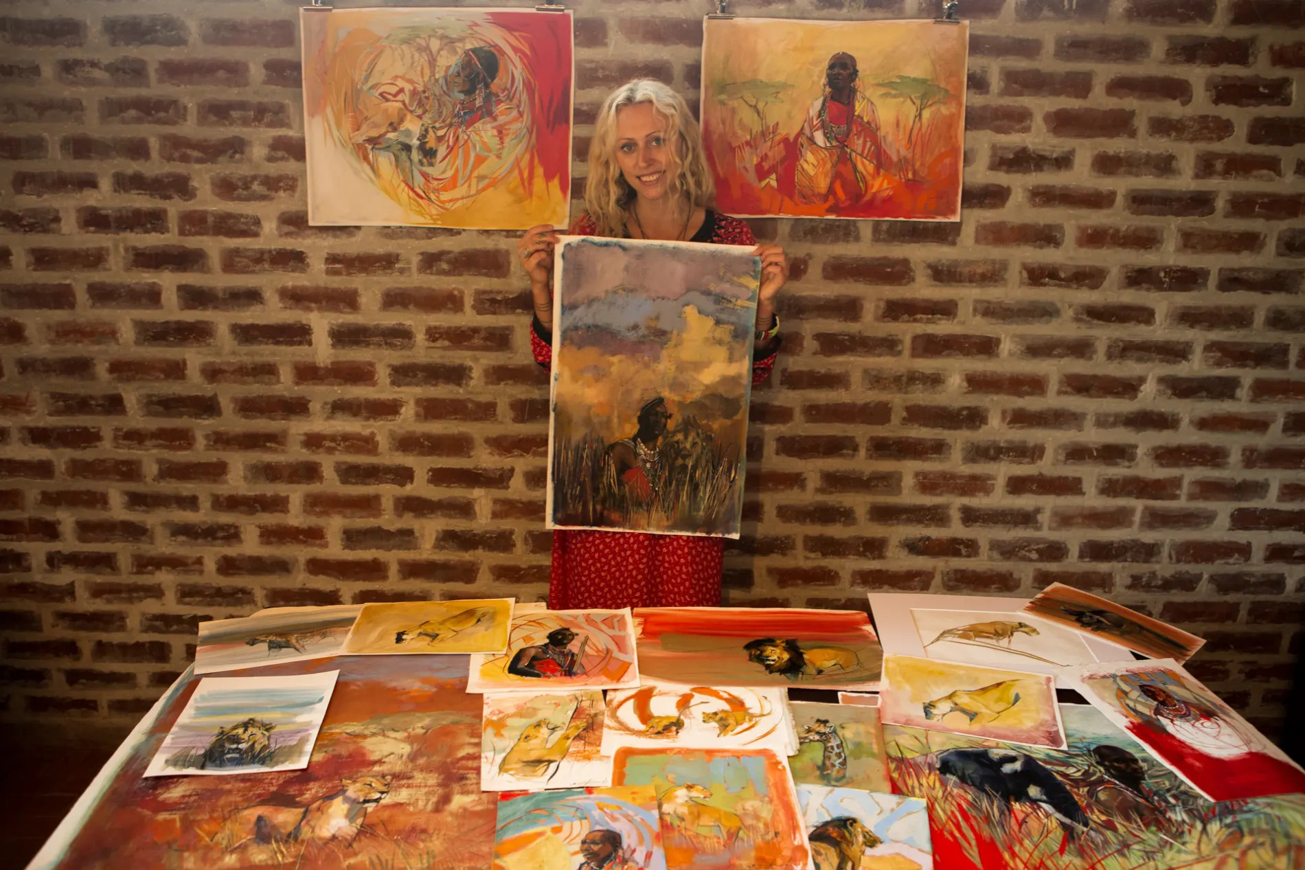 Emily Lamb holding artworks