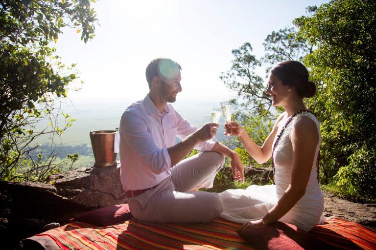 Happy couple toast on the Out of Africa Kopje