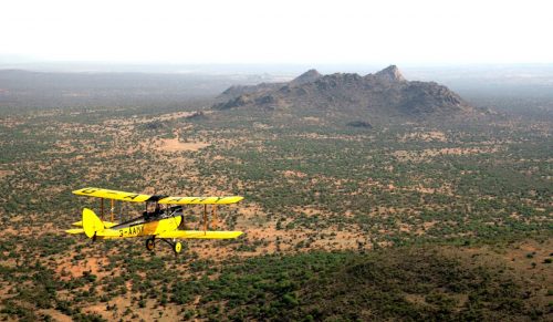 G-AMMY plane as it flies over Kenyan Landscape