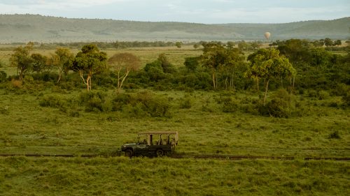 An Angama vehicle exploring the Mara as seen from a hot air balloon