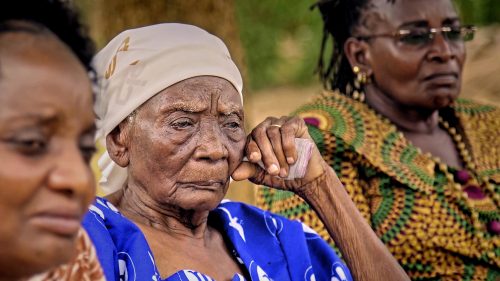 Grandma at the cleansing supported by her two daughters
