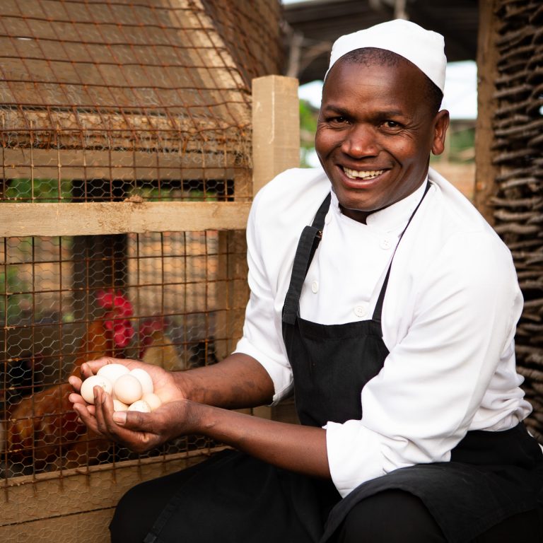 Chef Daniel Katoli fetching eggs from Angama Mara chicken coop