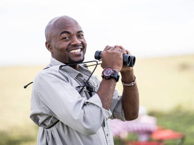 Guide Douglas with binoculars in the Maasai Mara