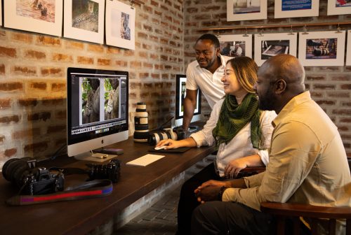 Guests learning the magic of editing — a crucial step in getting a brilliant photograph 