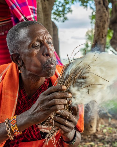 A Maasai elder demonstrating how to smoke out bees