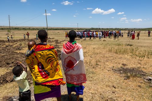 Maasai women look on as the crowd gathers