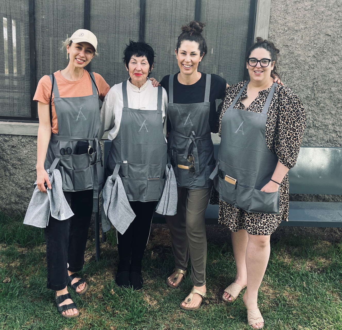 Claris, Annemarie, Alison and Eden, armed with aprons and cloths