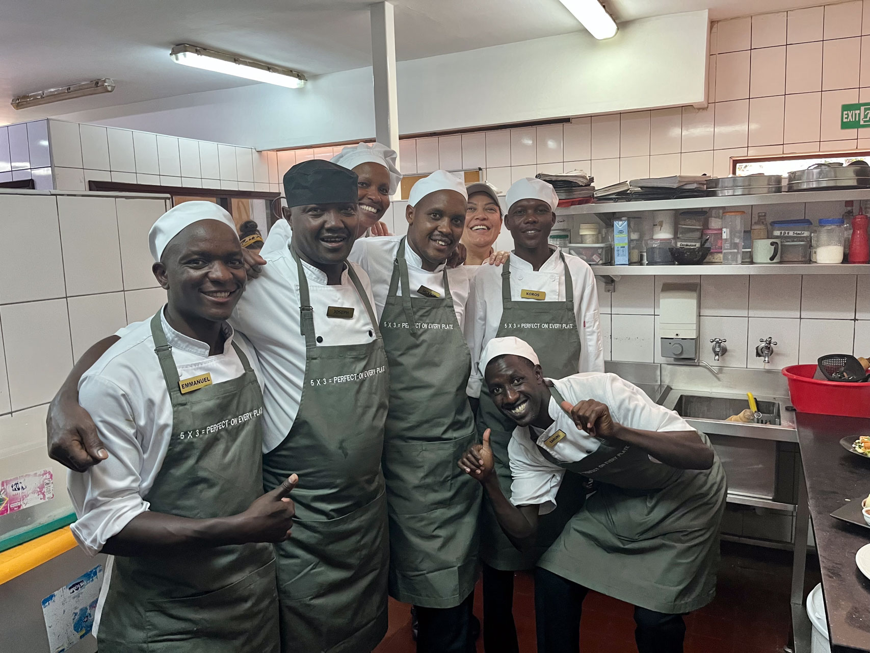 The Mara kitchen team rocking their new custom training aprons