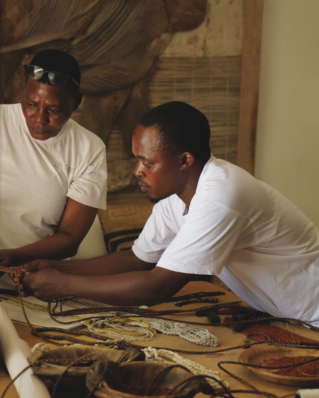 Artisan, Hamisi , working on a beaded shoulder piece