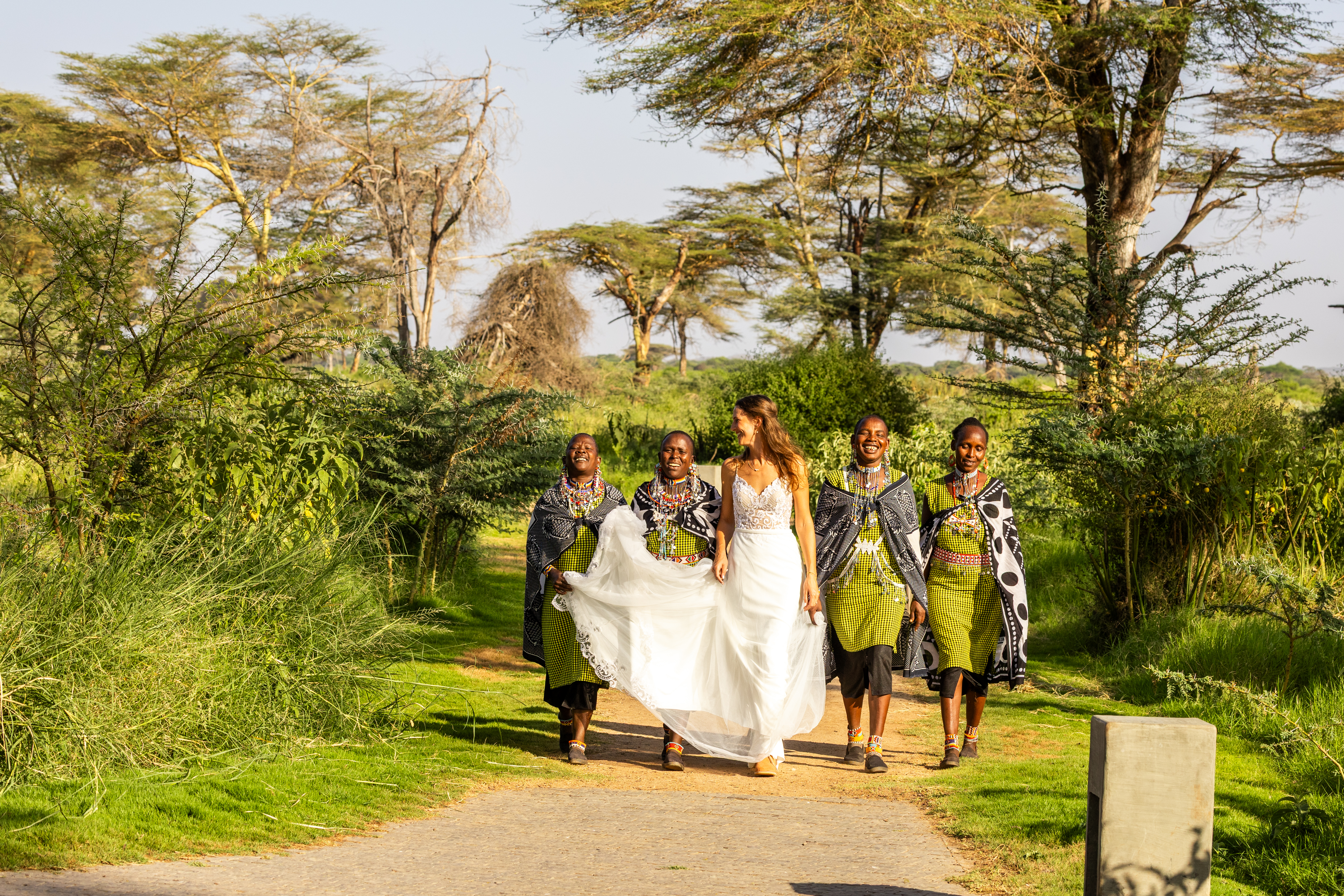 The sound of Maasai Mamas carrying through the trees, their songs a tribute just for you