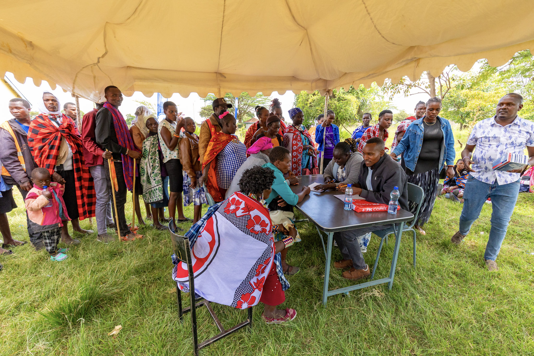 Under canvas shade, registration desks stayed busy