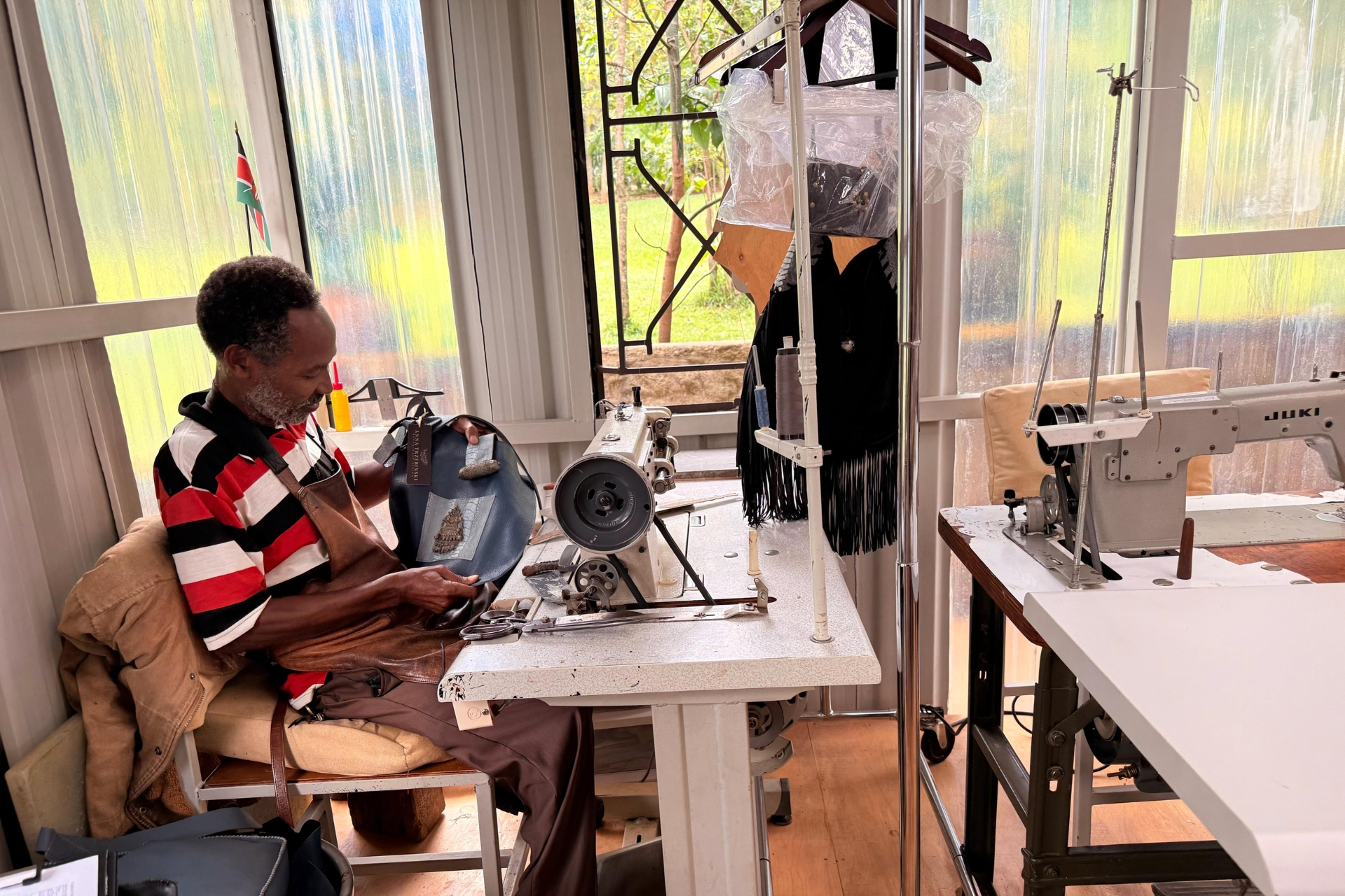 Mwalimu, a skilled leather fundi, at his machine